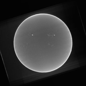 O I 8446 (~) continuum, excess light on plages also, but see at four o’clock the dark patch and the light blanket on the limb